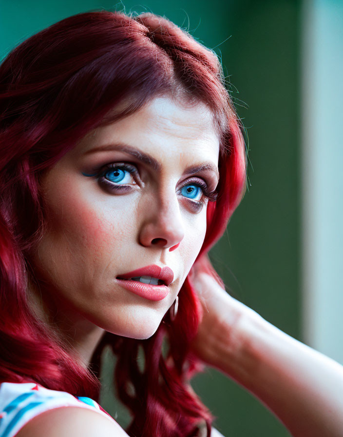 Vibrant red hair and striking blue eyes on a pensive woman