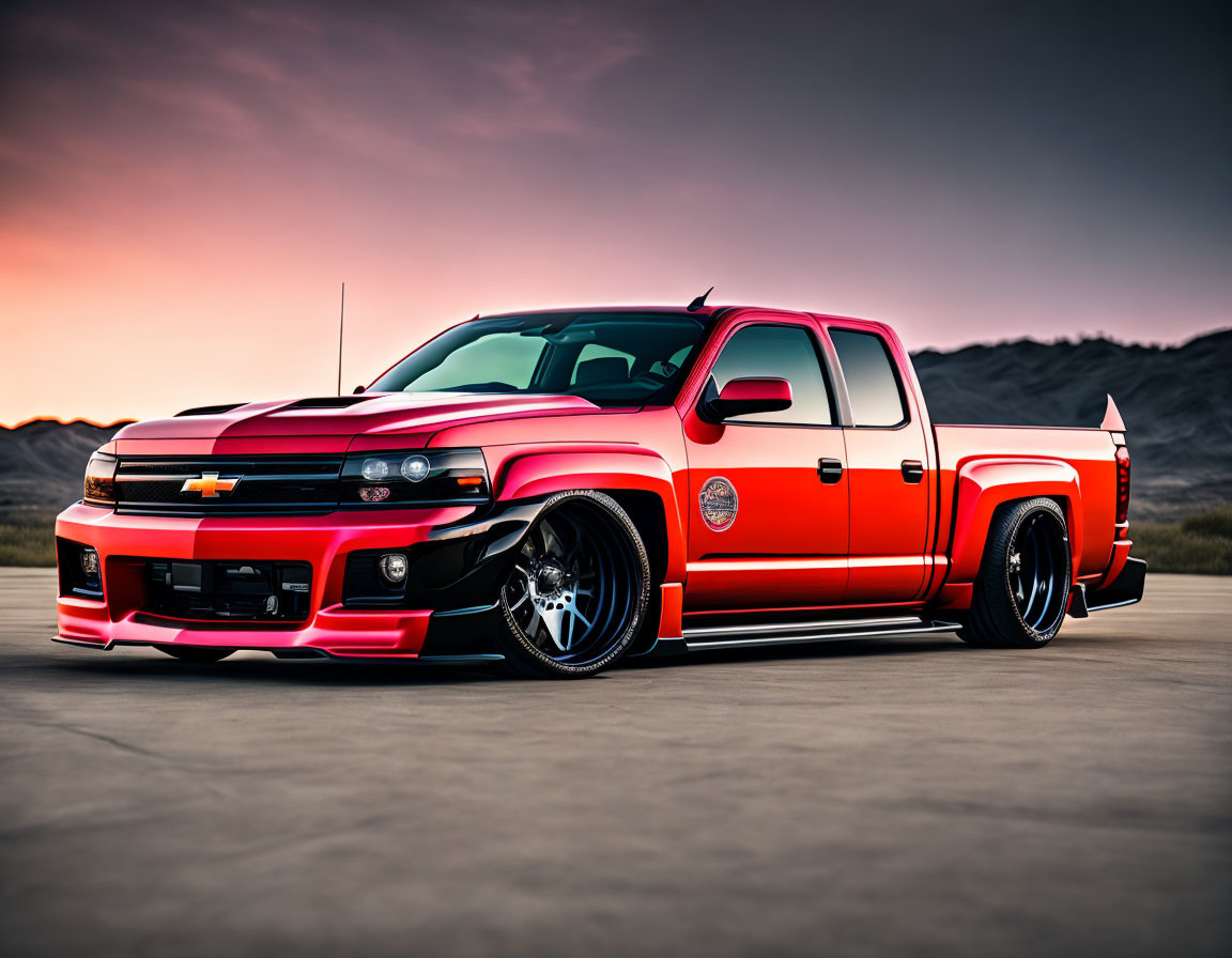 Customized Red and Black Chevrolet Silverado with Lowered Suspension and Aftermarket Wheels on Open Tarmac