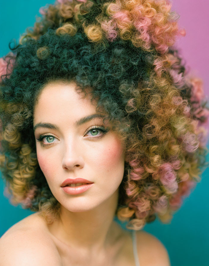 Colorful portrait of woman with curly hair and green eyes on turquoise backdrop