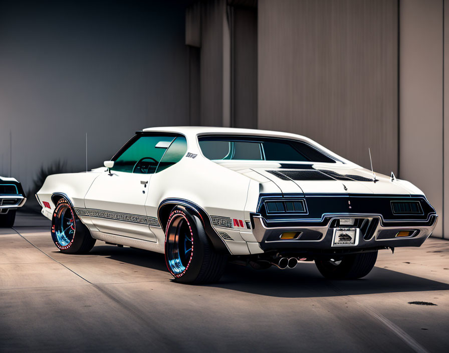 Vintage white muscle car with blue accents parked outdoors