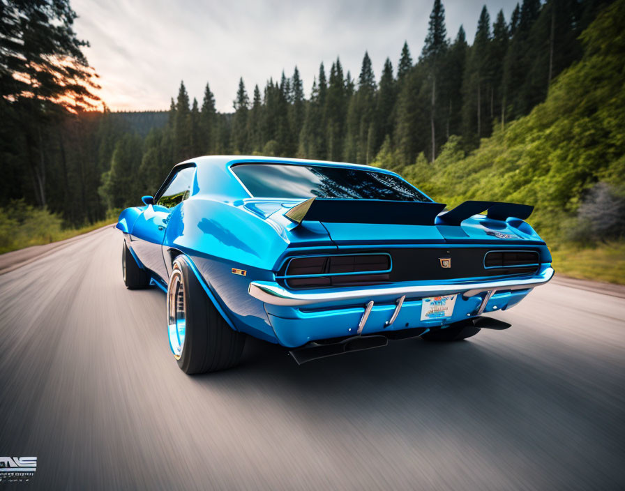 Blue vintage muscle car on road with trees and sunset sky