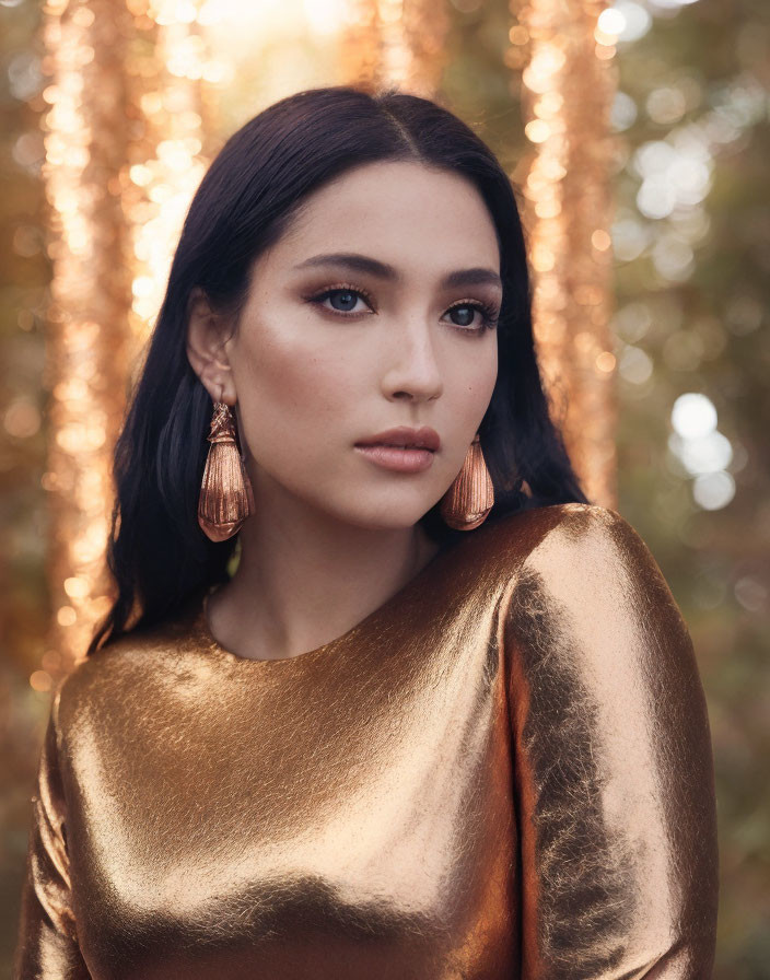 Woman in Golden Top with Large Copper Earrings Against Autumnal Trees