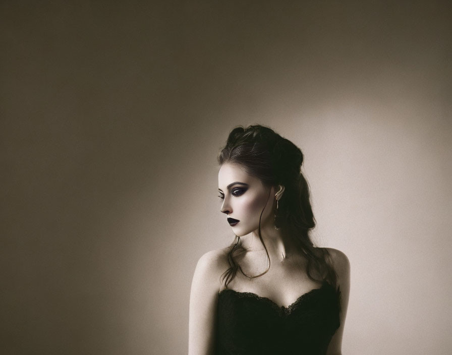 Vintage-style portrait of woman with dark makeup and upstyled hair in black dress and hoop earrings on muted