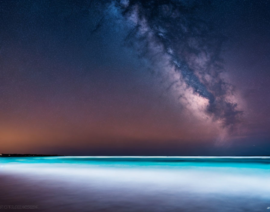 Starry Night Sky with Milky Way over Blue Shoreline at Twilight