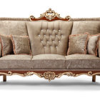 Colorful Ornate Sofa with Gold Accents and Mixed Patterns on White Background