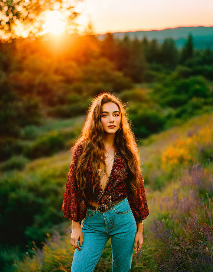 Woman with Long Hair in Sunlit Field at Sunset Wearing Patterned Top and Blue Jeans