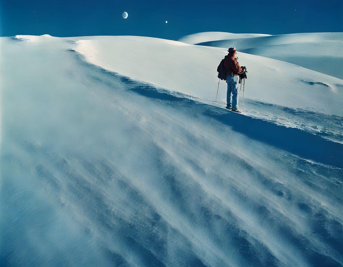 Hiker in Snowy Landscape with Moon and Blue Sky