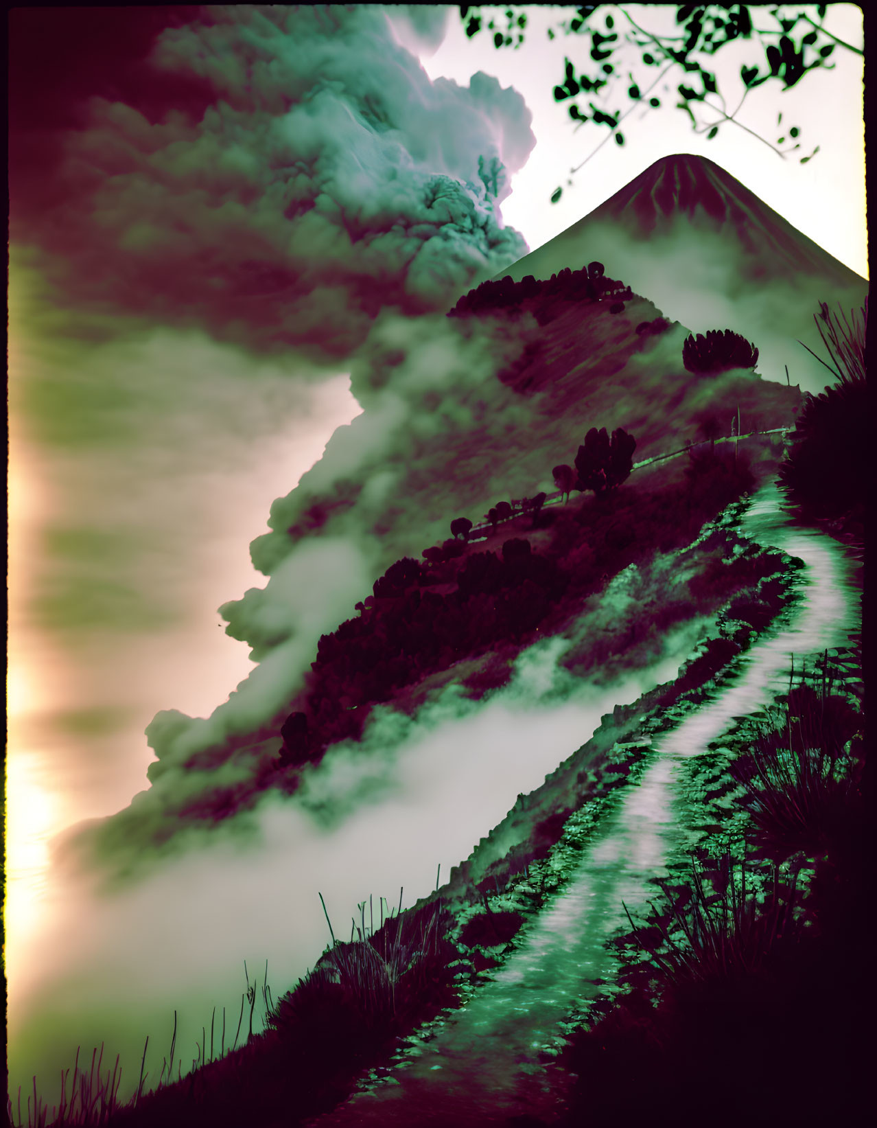 Volcano smoking over lush greenery on winding road