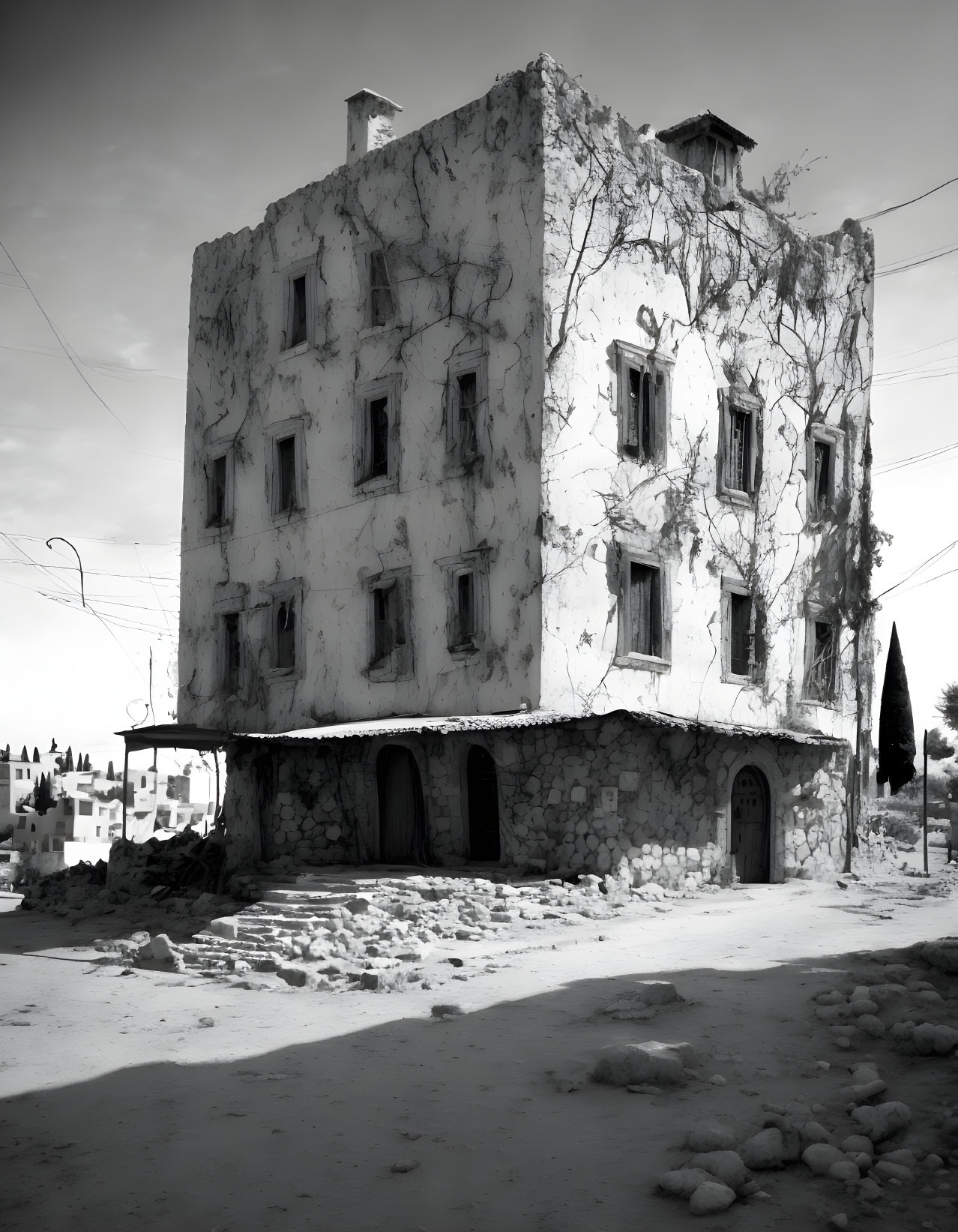 Decrepit multi-story corner building under cloudy sky