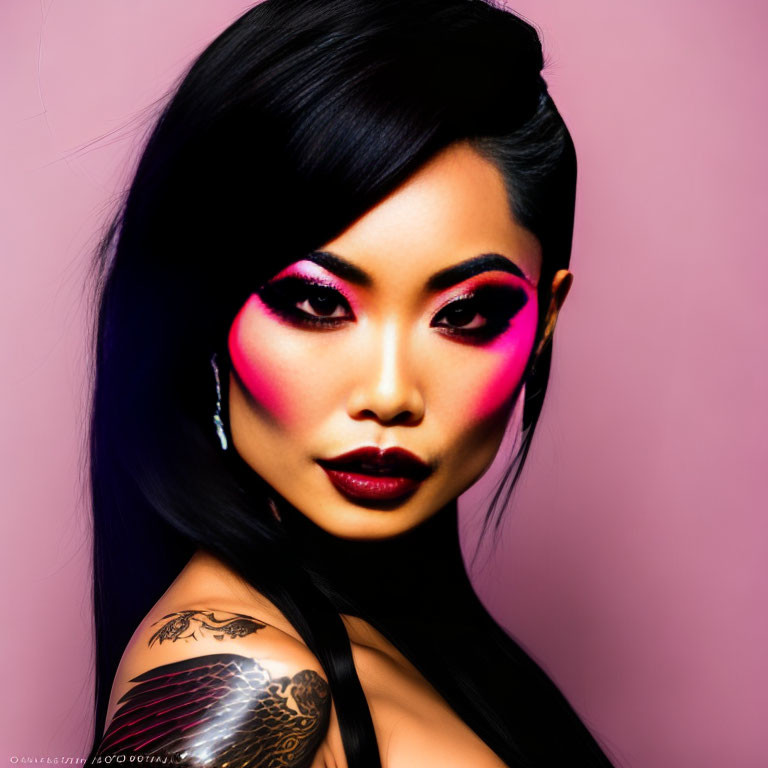 Vivid pink eyeshadow and dark lipstick on woman with eagle tattoo