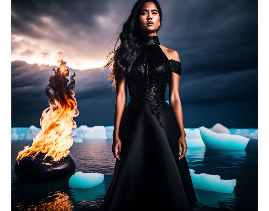 Woman in black dress on water with icebergs and fiery torch against dramatic sky