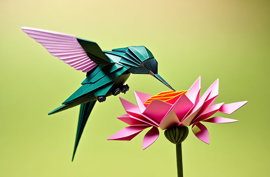 Origami hummingbird and flower on green background