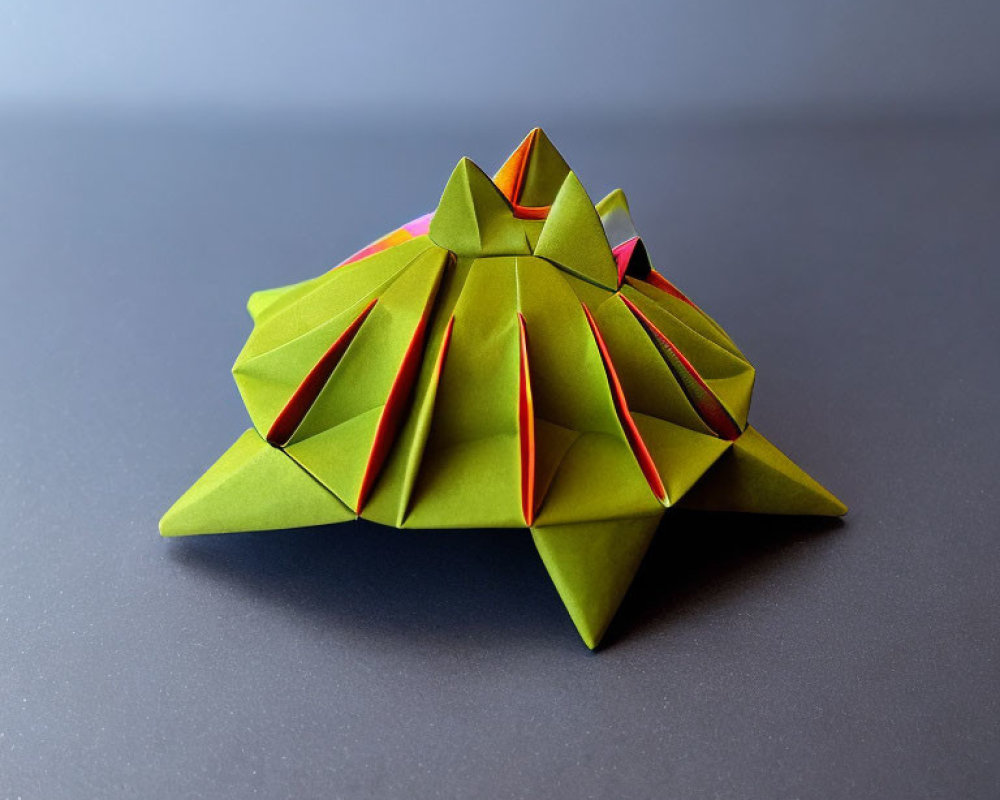 Green Modular Origami Pyramid Structures on Gradient Blue Background