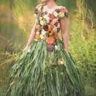 Woman in Floral Gown Standing in Garden