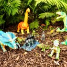 Colorful Stylized Dinosaur Artwork in Lush Tropical Setting