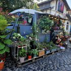 Vintage Double-Decker Bus Covered in Flowers on City Street