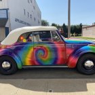 Colorful Car with Cosmic Paint Job and Futuristic Cityscape Background