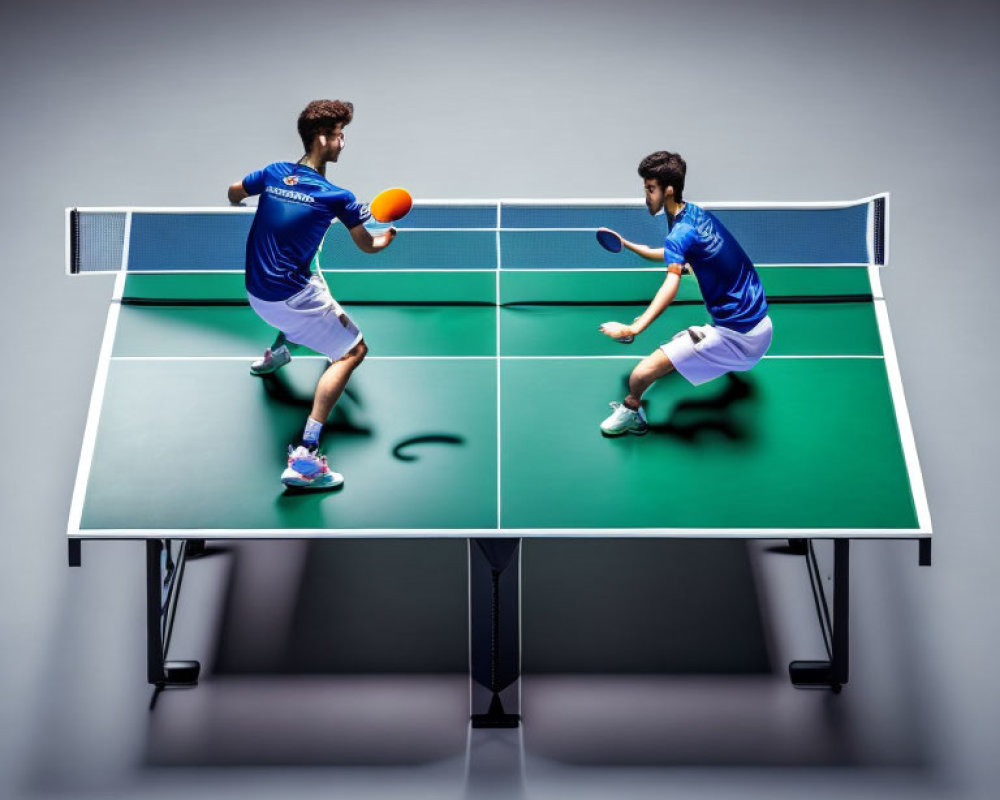 Two people playing table tennis in blue shirts on gray background