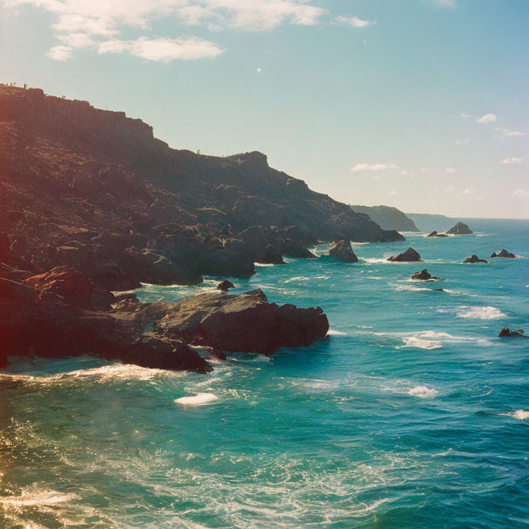 Rocky Cliffs and Tranquil Blue Sea Viewed from Rugged Coastline