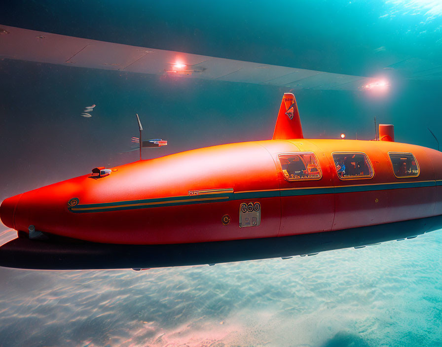 Bright red submarine with internal compartments underwater in clear blue.