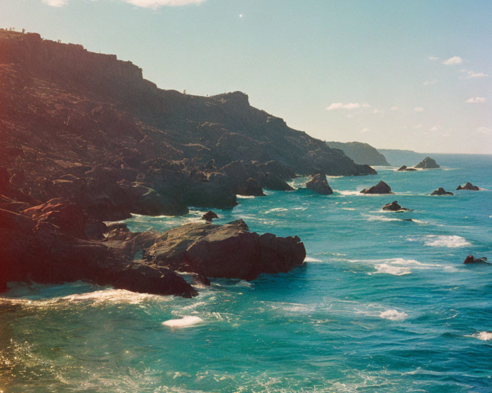 Rocky Cliffs and Tranquil Blue Sea Viewed from Rugged Coastline