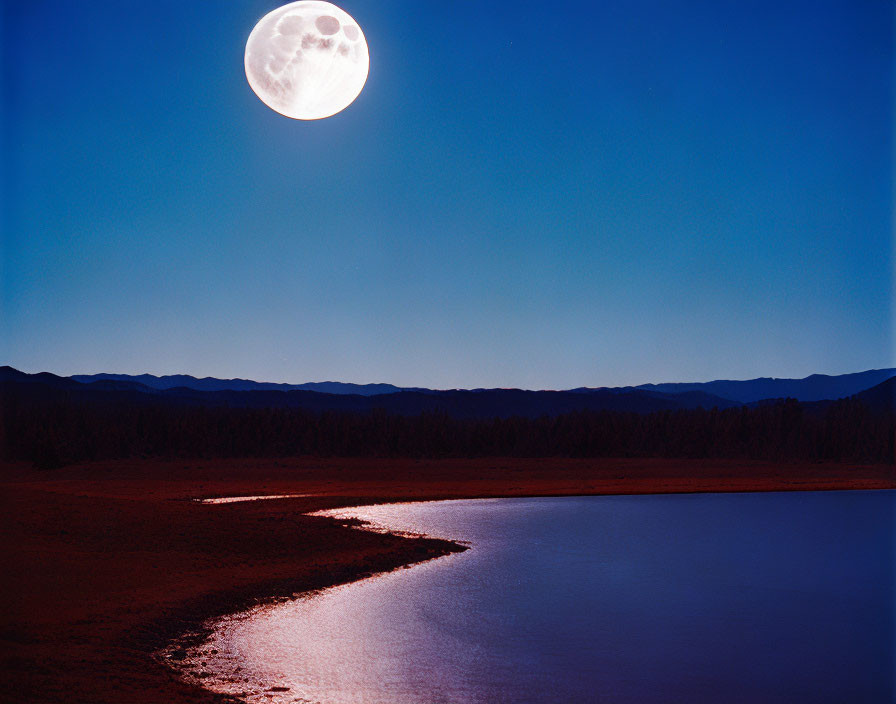 Tranquil lake under full moon and forested hills