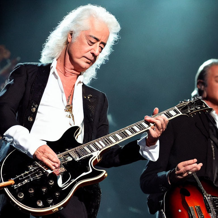 White-Haired Musician Plays Electric Guitar on Stage