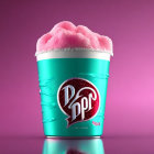 Turquoise cup with Dr. Pepper logo and pink cotton candy on pink background