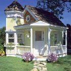 Charming two-story house with white picket fence and lush garden.