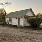 Rustic Cottage Surrounded by Vibrant Flower Garden