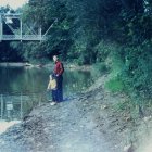 Serene river scene with two people fishing