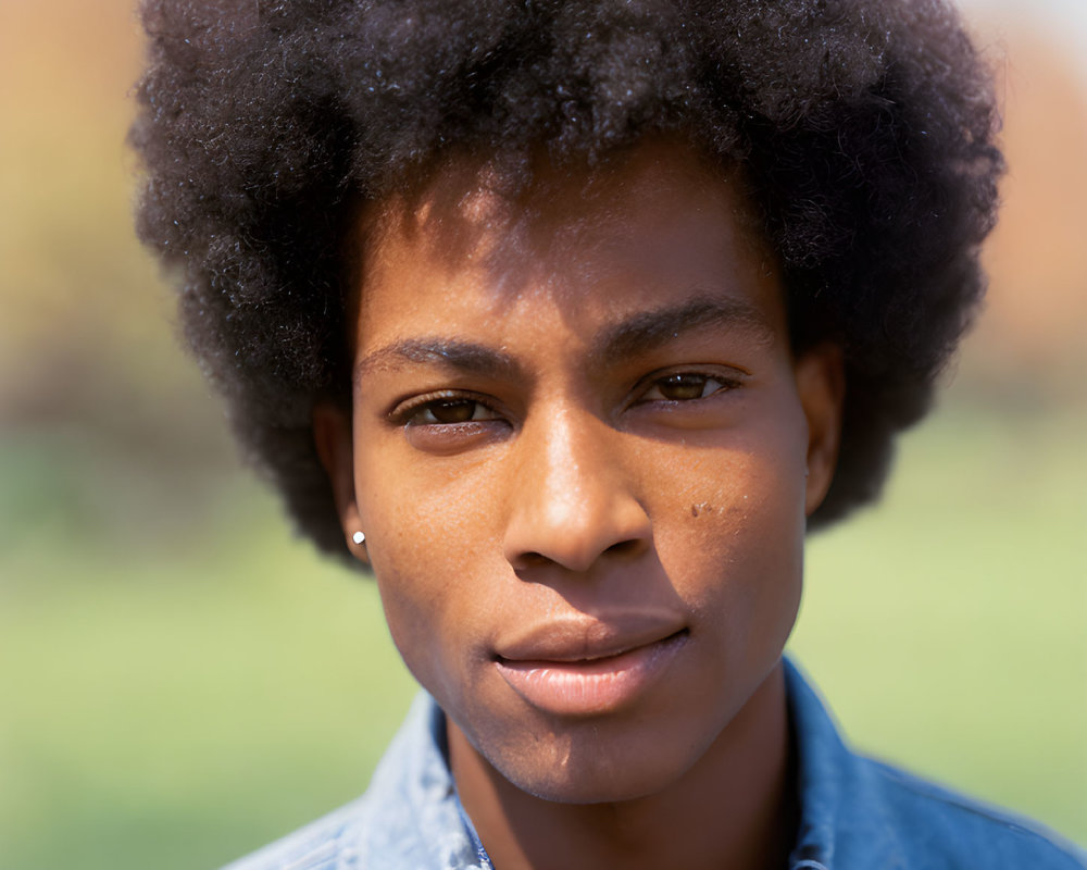 Person with Afro in Denim Shirt Outdoors - Close-up Shot