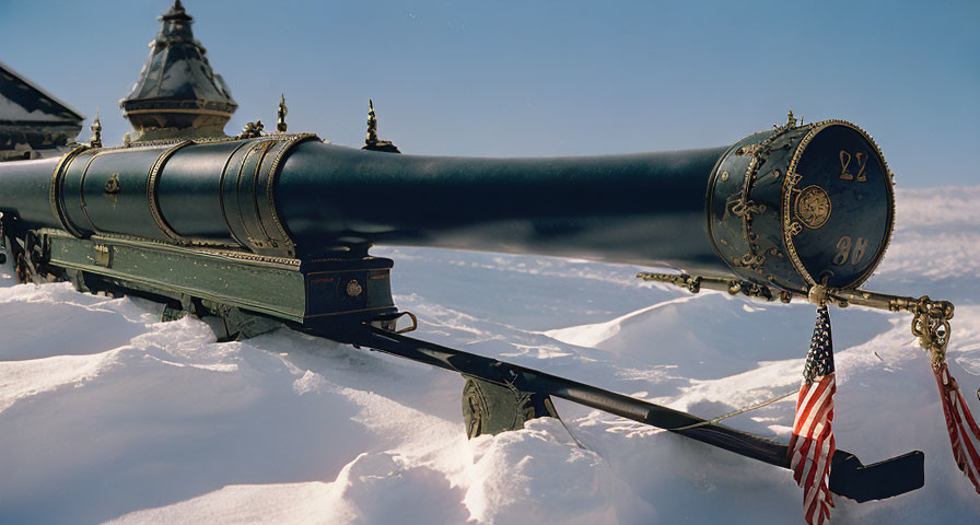 Historical cannon on carriage with intricate decorations, American flags, snowy landscape, and domed building