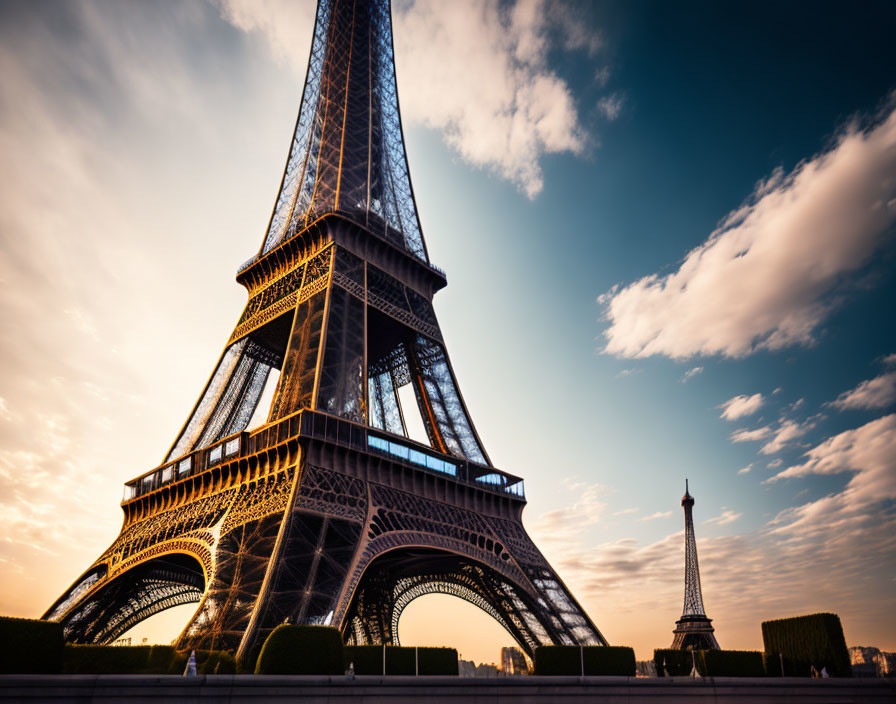 Iconic Eiffel Tower silhouette against dramatic sunset sky