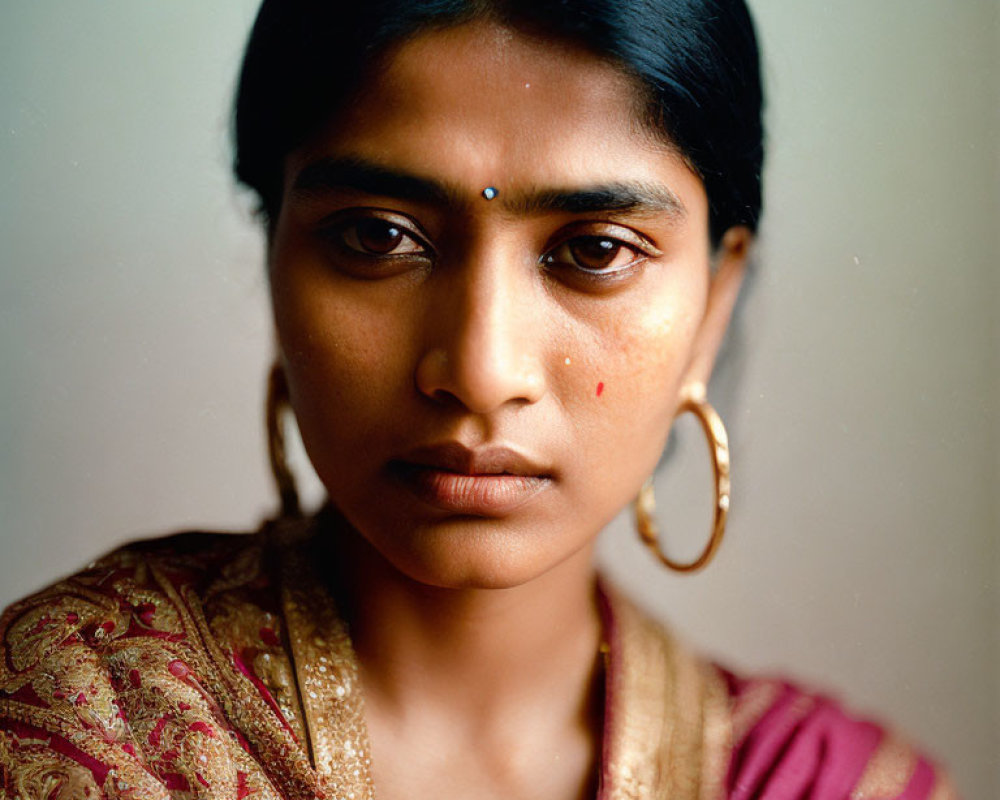 Traditional woman in sari with gold earrings and bindi