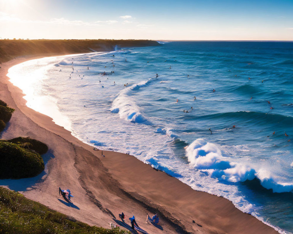 Scenic beach with surfers, crashing waves, and sunny sky