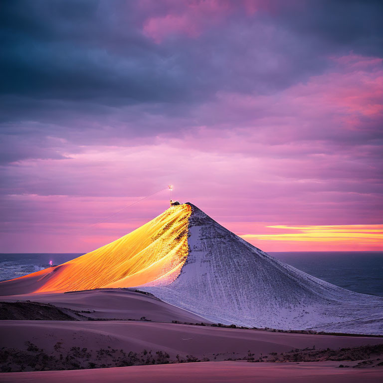 Snowy Mountain Peak at Sunrise with Purple Sky and Orange Light