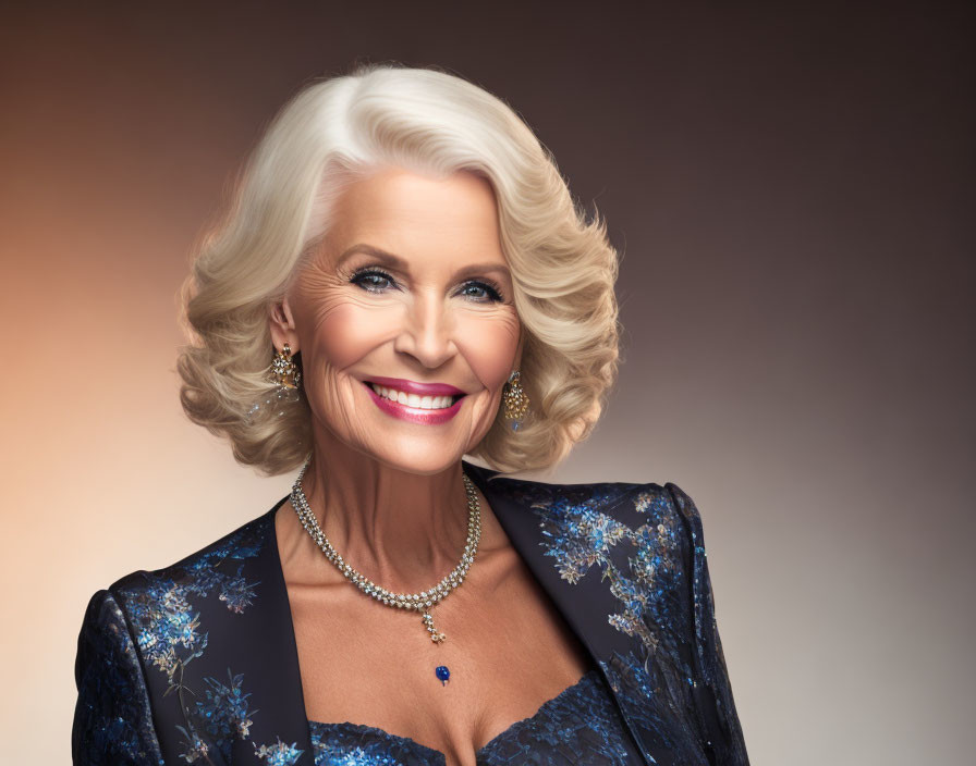 Sophisticated older woman in white hair, pearl jewelry, blue floral dress, smiling on brown backdrop