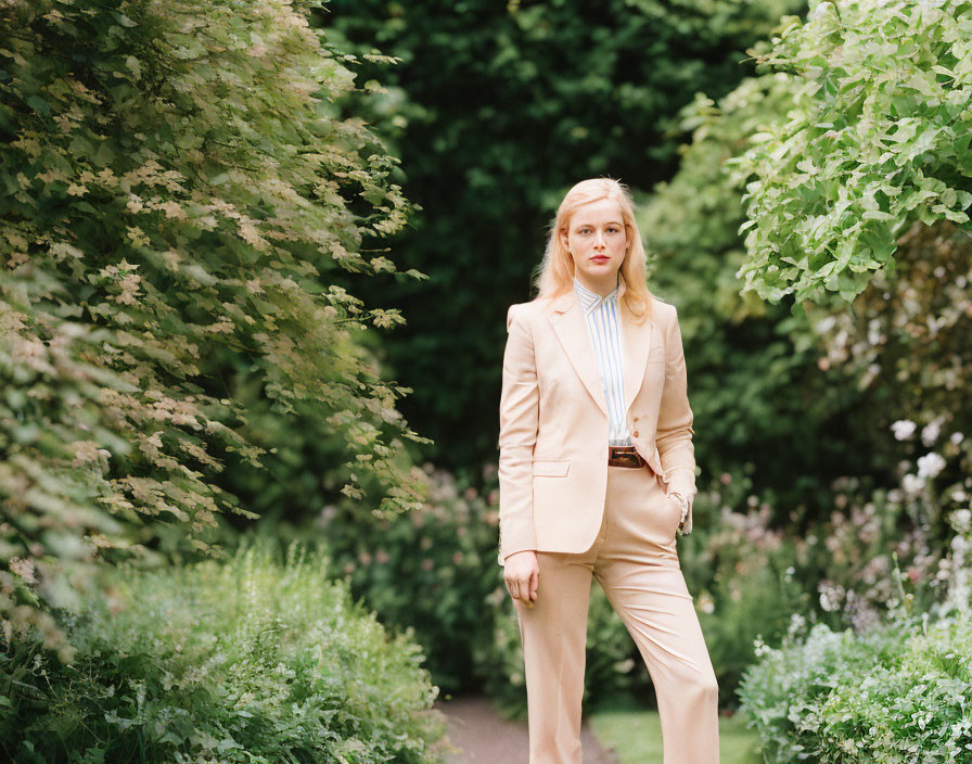 Professional woman in beige suit on lush garden path