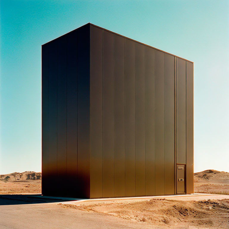 Monolithic dark brown structure in desert landscape