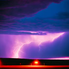 Vivid purple lightning storm over silhouetted forest with red road lights