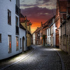 Cobblestone street at dusk with old white buildings under moody sky