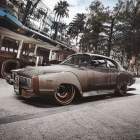 Vintage car with weathered patina in rustic setting