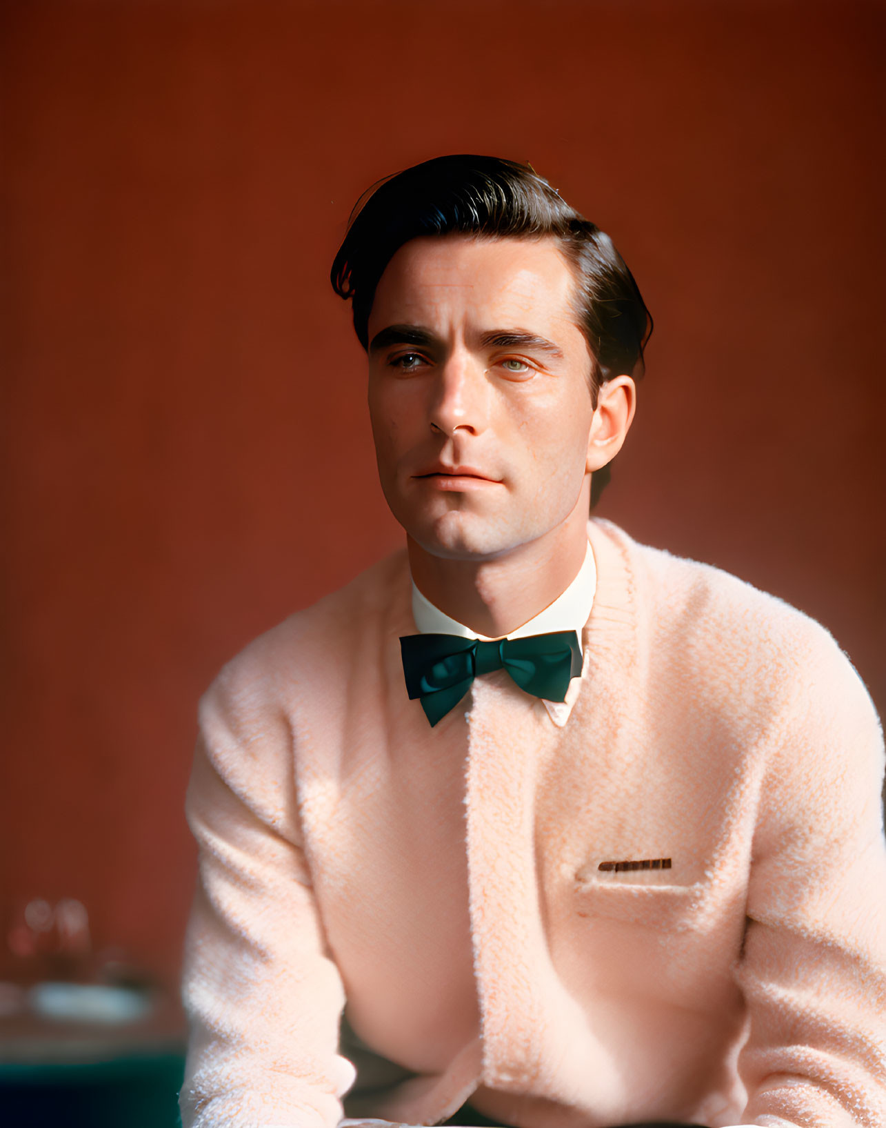 Man in Pink Fuzzy Sweater and Green Bow Tie on Red Background