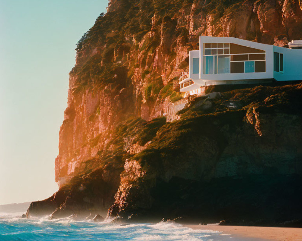 Modern House on Steep Cliff Overlooking Beach at Sunrise