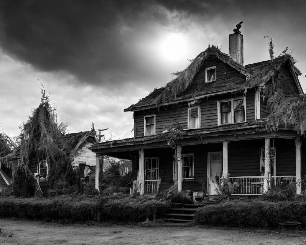 Dilapidated two-story wooden house with porch under dark sky