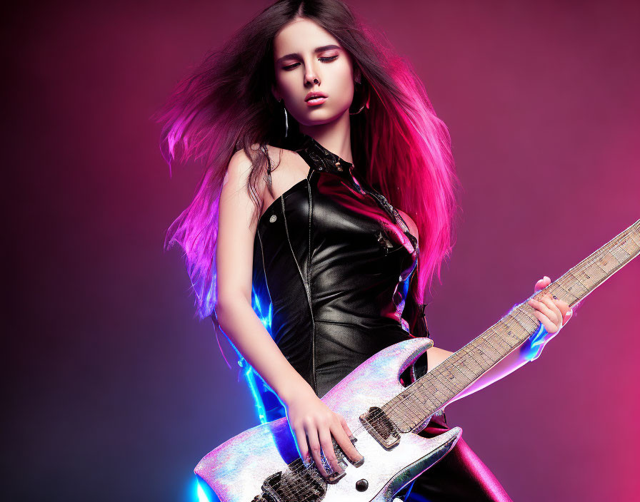 Woman with flowing hair holding electric guitar on vivid pink background