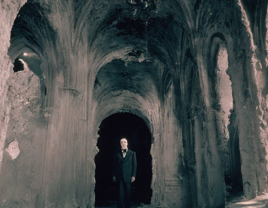 Ancient underground chamber with fading walls and chandelier