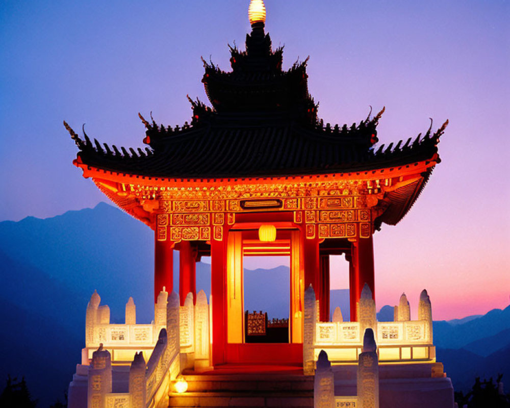 Traditional Chinese Pagoda Illuminated at Dusk with Mountainous Backdrop