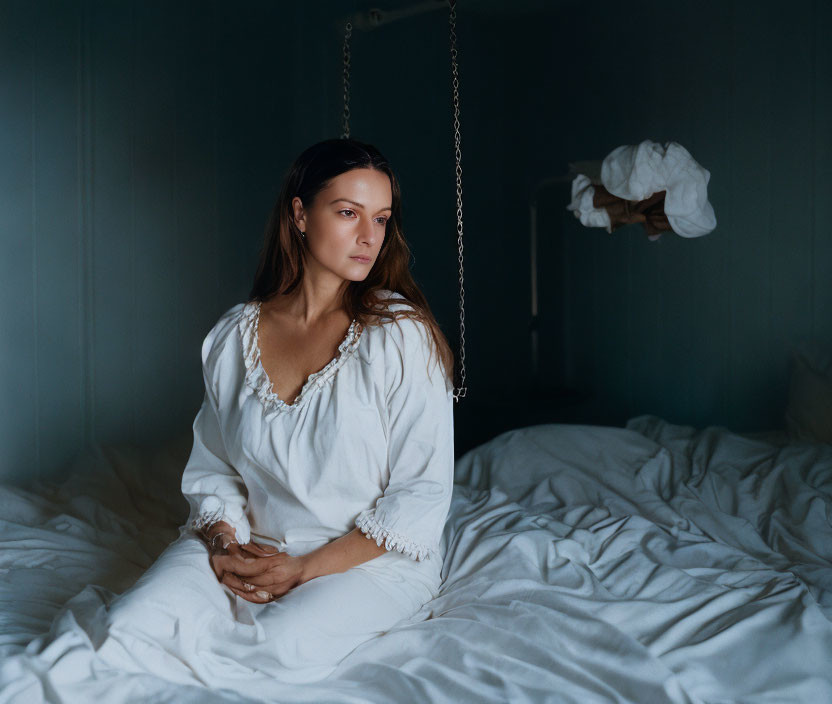 Woman on Swing in Dimly Lit Room with White Decor